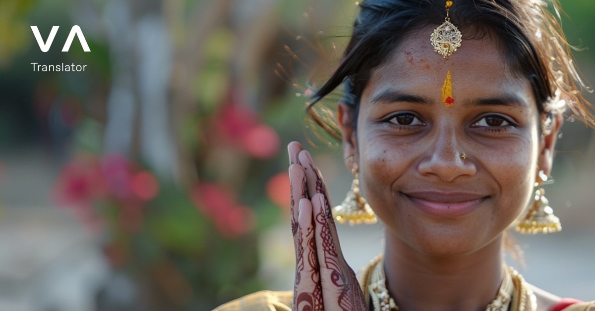 Una mujer con atuendo tradicional indio con las manos en gesto de saludo, representando cómo decir hola en varios idiomas.