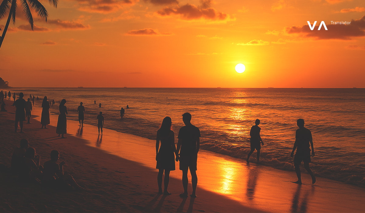Una pareja observa una hermosa puesta de sol naranja en una playa de Bali, con siluetas de otras personas alrededor.